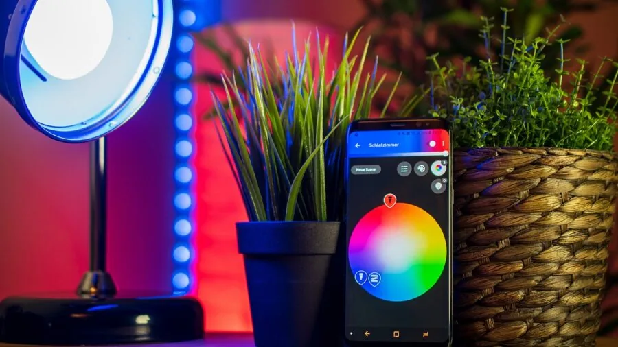 Person using smartphone app to control home automation system in modern living room