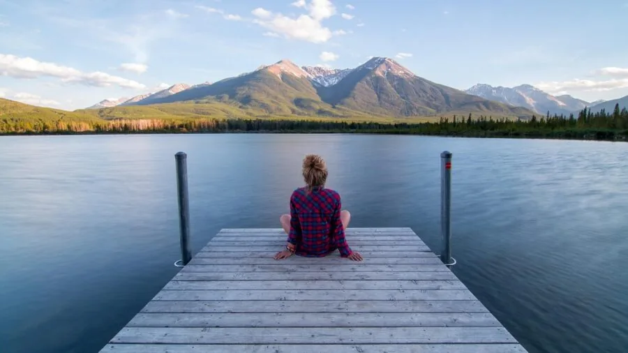 Person using smartphone to capture expansive landscape vista outdoors
