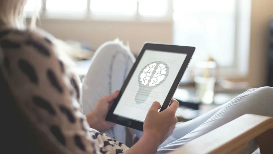 Person using tablet for multitasking work with multiple applications open