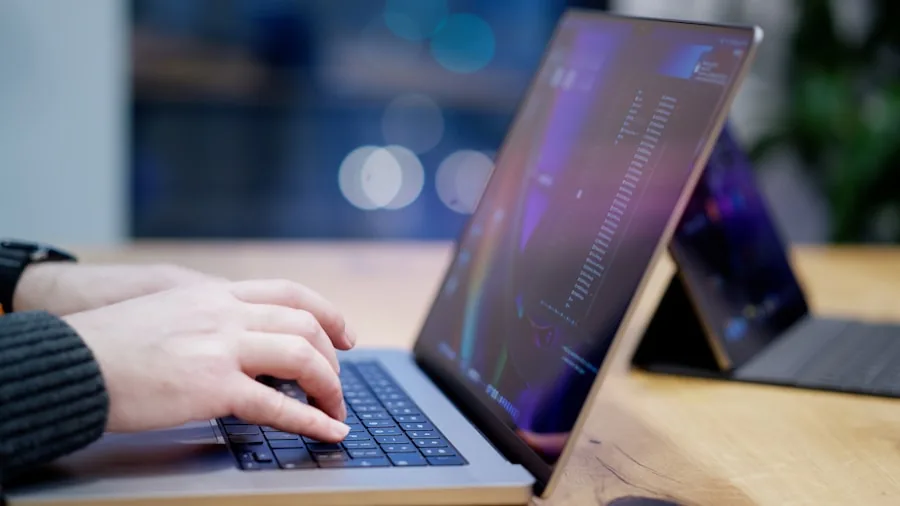 Person using tablet with keyboard at a wooden desk in a bright, modern workspace