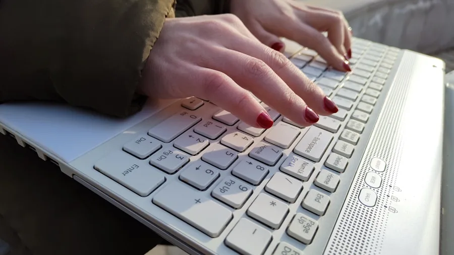 Person using tablet with wireless keyboard at desk for productivity work