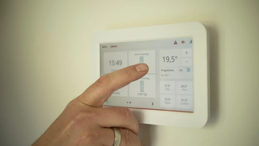 Person using voice assistant to control home automation system from living room