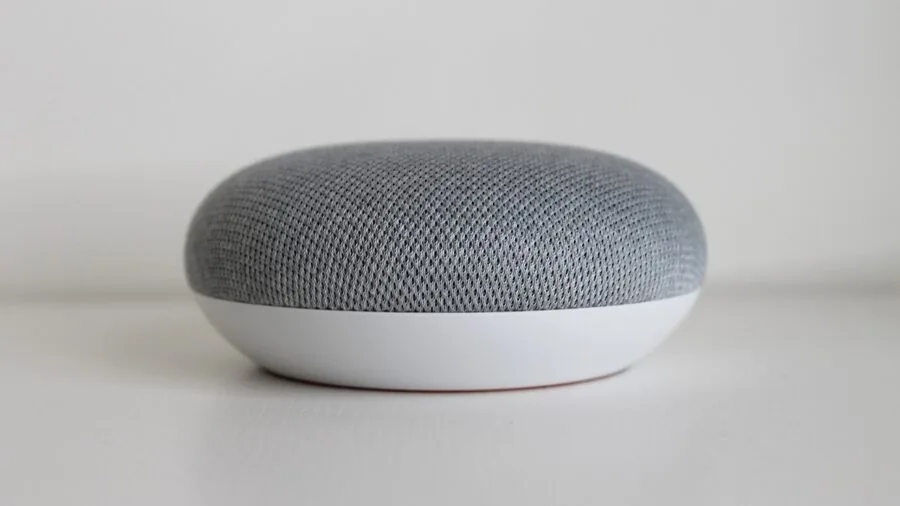 Person using voice commands in modern living room with smart home devices