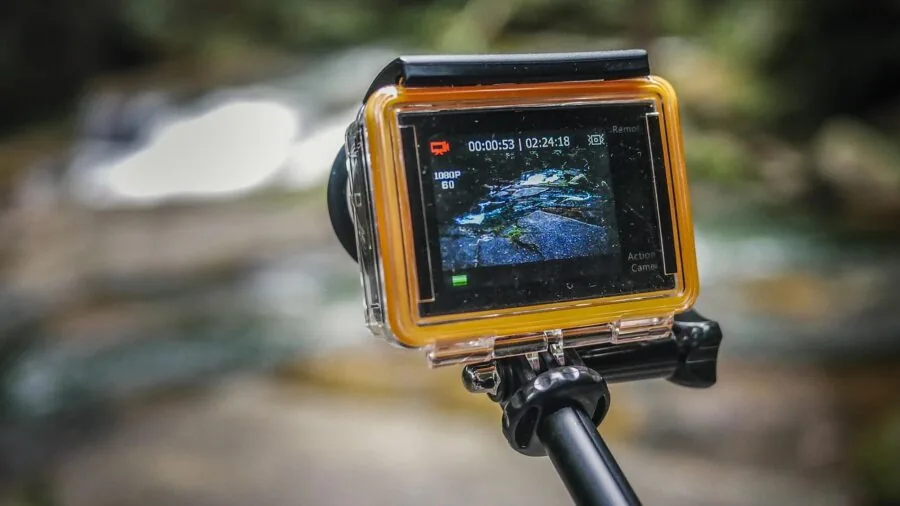 Person using waterproof camera while swimming in ocean water