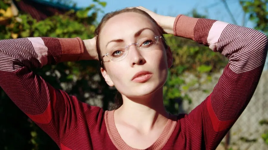 Person wearing eyeglasses outdoors, demonstrating proper frame fit and comfort during daily wear