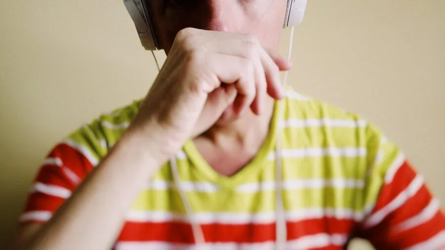 Person wearing over-ear wireless headphones while enjoying outdoor activity, demonstrating modern audio technology in everyday life