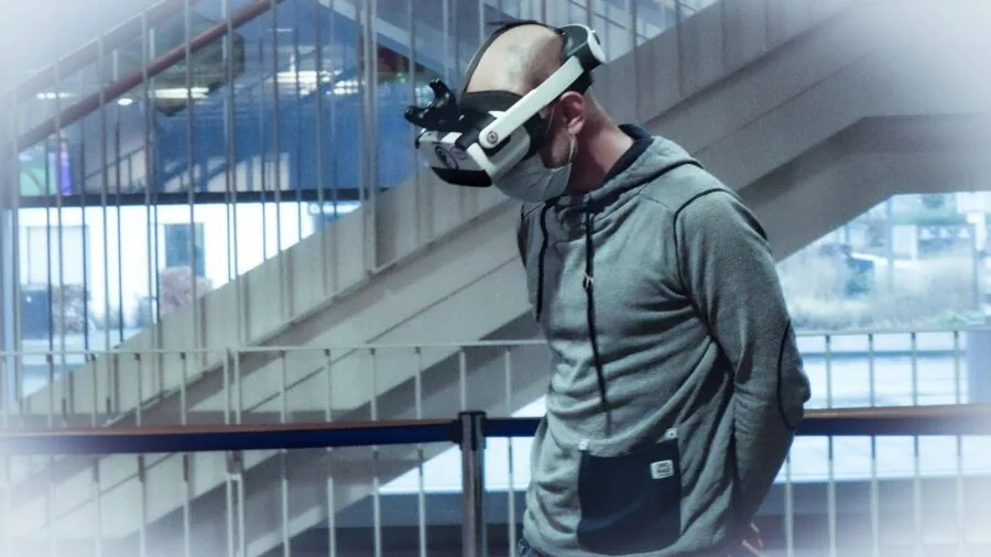 Person wearing VR headset in living room, immersed in virtual reality gaming experience