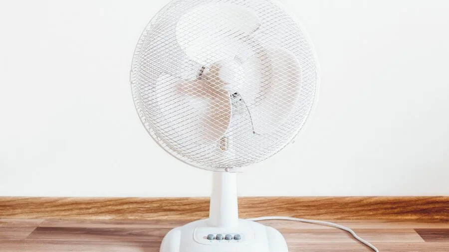 Person working at desk with air circulation in comfortable home office environment