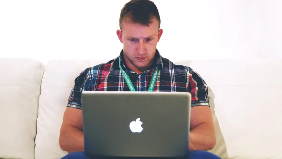 Person working at desk with computer in home office setup