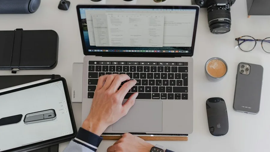 person working at desk with multiple devices