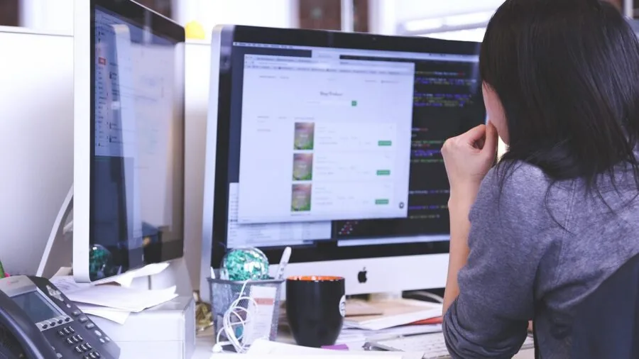 Person working at desk with reliable wired network connection for video calls and file transfers