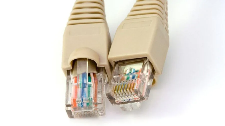 Person working at desk with wired network connection for gaming performance