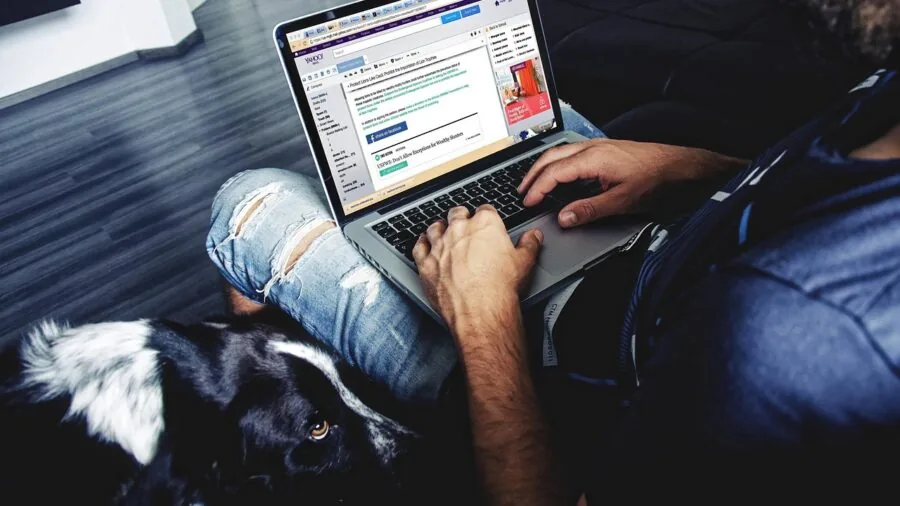 Person working at desk with wireless computer setup and devices in modern home office environment