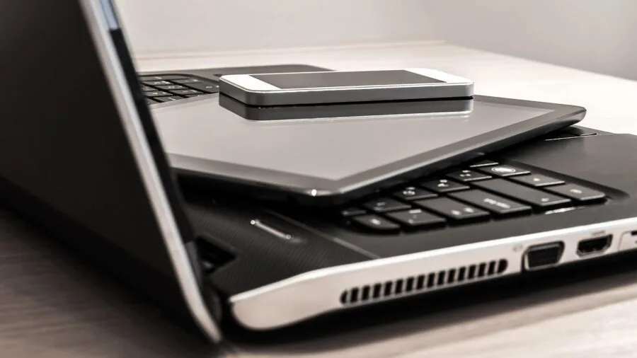Person working at desk with wireless technology and connectivity setup