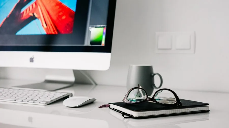 Person working at home office desk with proper monitor height and ergonomic seating position