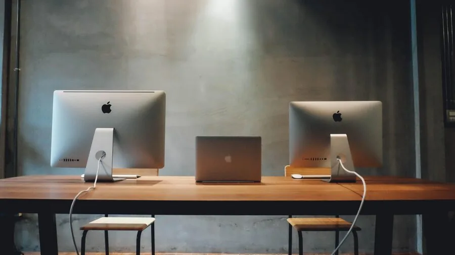 Person working at organized desk with audio equipment and monitor setup