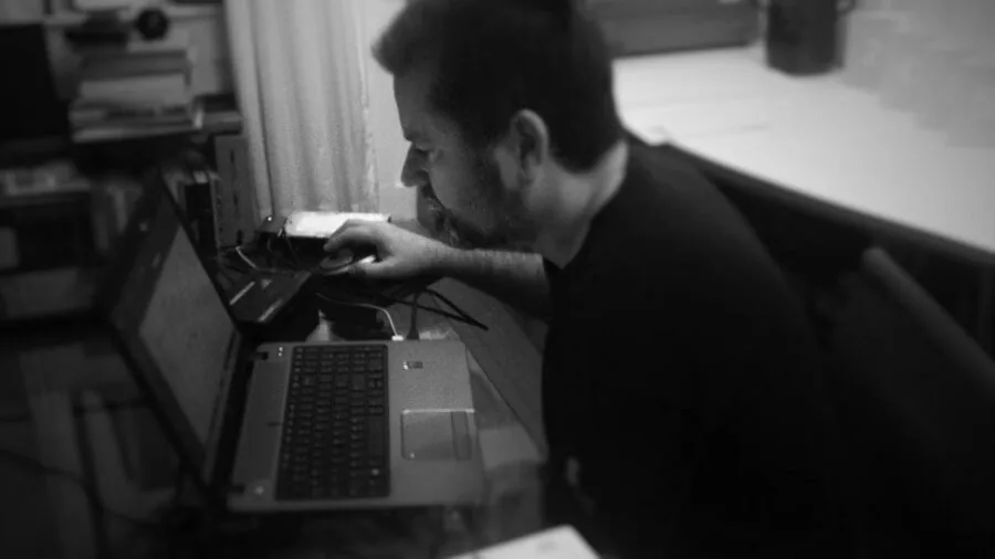 Person working on laptop at desk with professional setup, representing reliable computer hardware choices
