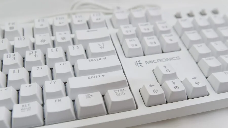 Person's hands actively typing on a mechanical keyboard during an intense gaming session