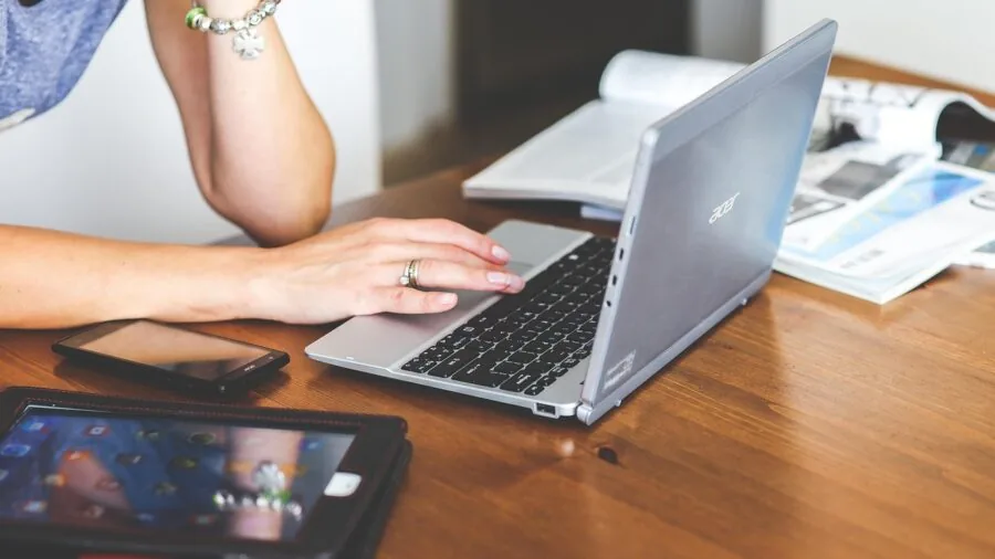 Person's hands actively typing on keyboard during extended gaming session with focused concentration