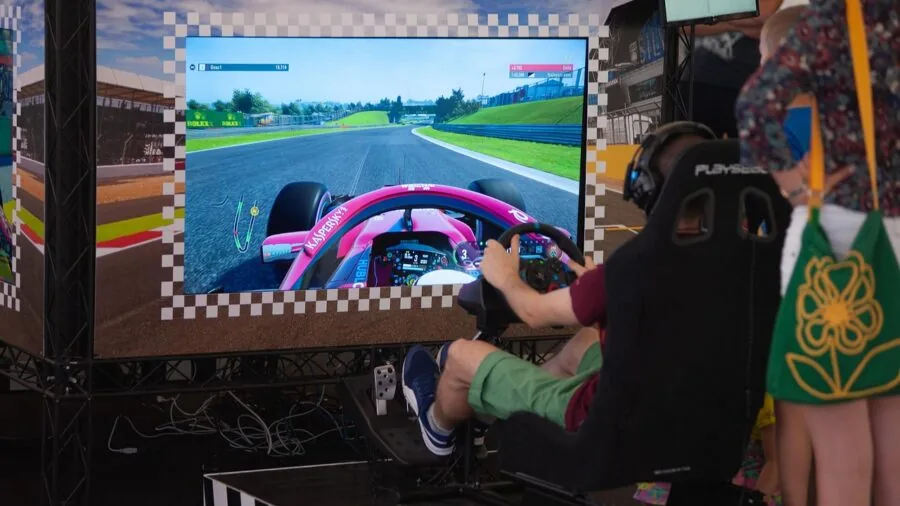 Person's hands gripping a racing wheel controller during an intense sim racing gaming session