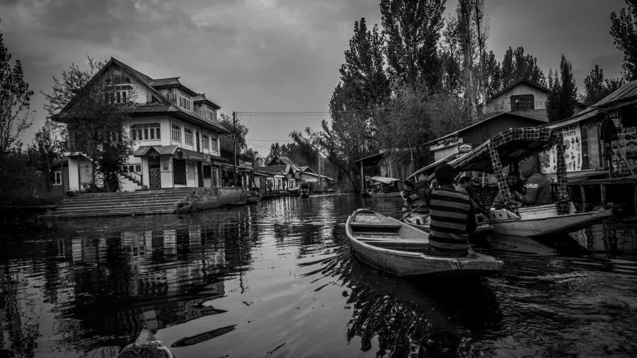 Photographer capturing expansive landscape with environmental context using wide angle perspective