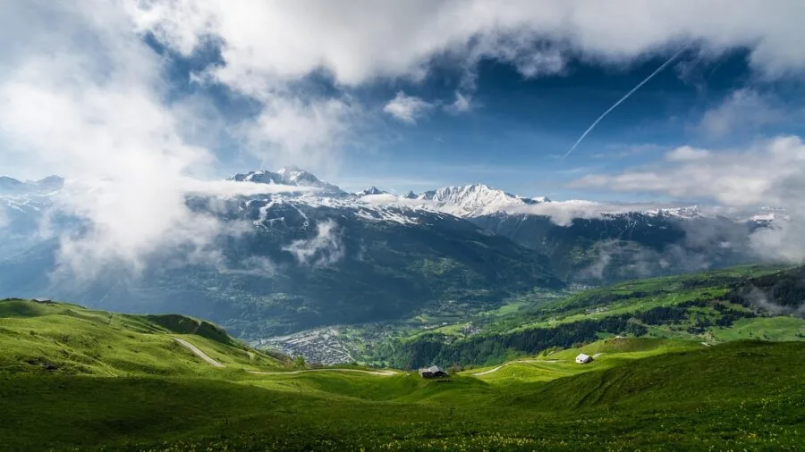 Photographer capturing expansive mountain landscape with wide angle lens technique