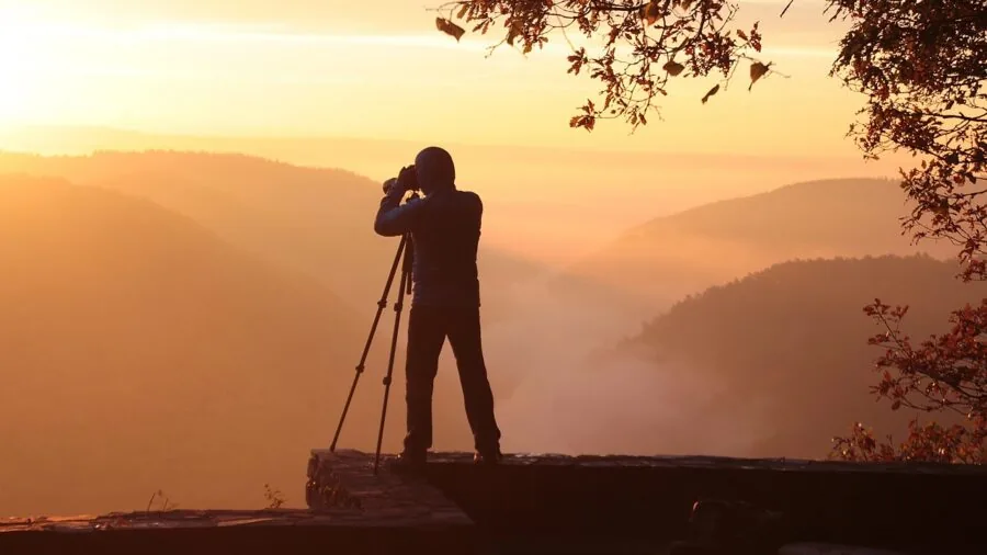 Photographer focusing on moving subject during outdoor shoot, demonstrating real-world autofocus application