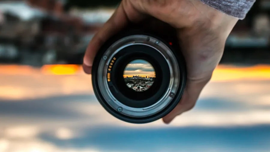photographer holding adapted camera lens