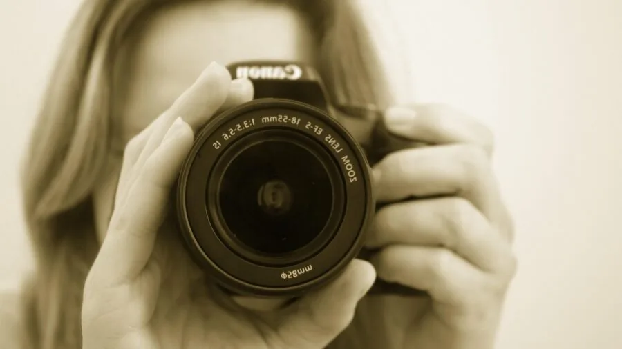 Photographer holding camera steady while capturing motion in natural lighting conditions