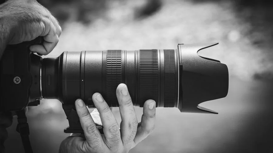 Photographer using camera to photograph distant mountains and landscape scenery