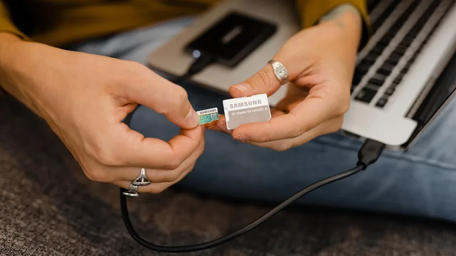 Professional connecting USB cables and peripherals to laptop at wooden desk workspace