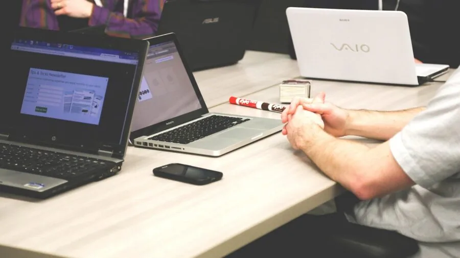 Professional designer working at computer workstation with focused concentration on digital creative task