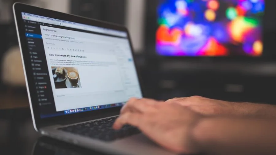 Professional focused on computer work at home office desk during daytime