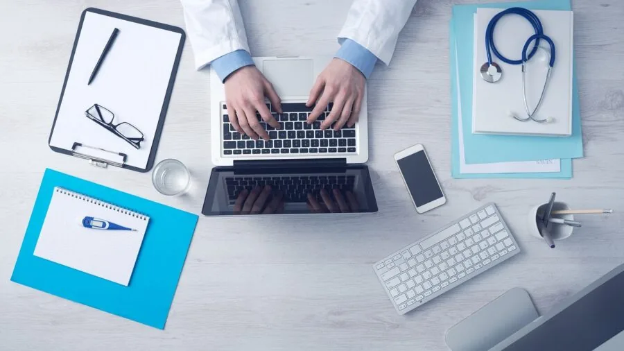 Professional focused on work at modern office desk with computer setup