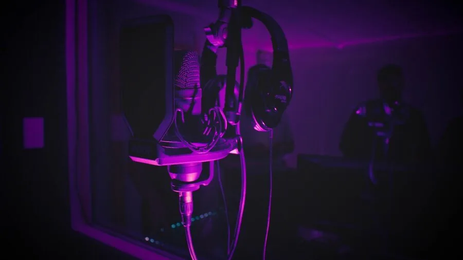 Professional home recording studio with acoustic panels and microphone setup for content creation
