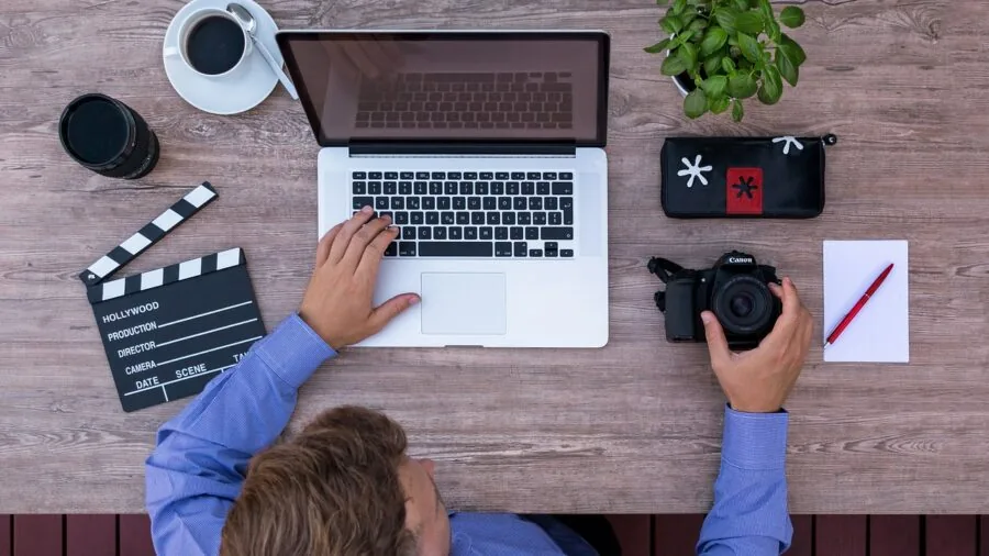 Professional in modern office workspace using computer monitor for focused work tasks