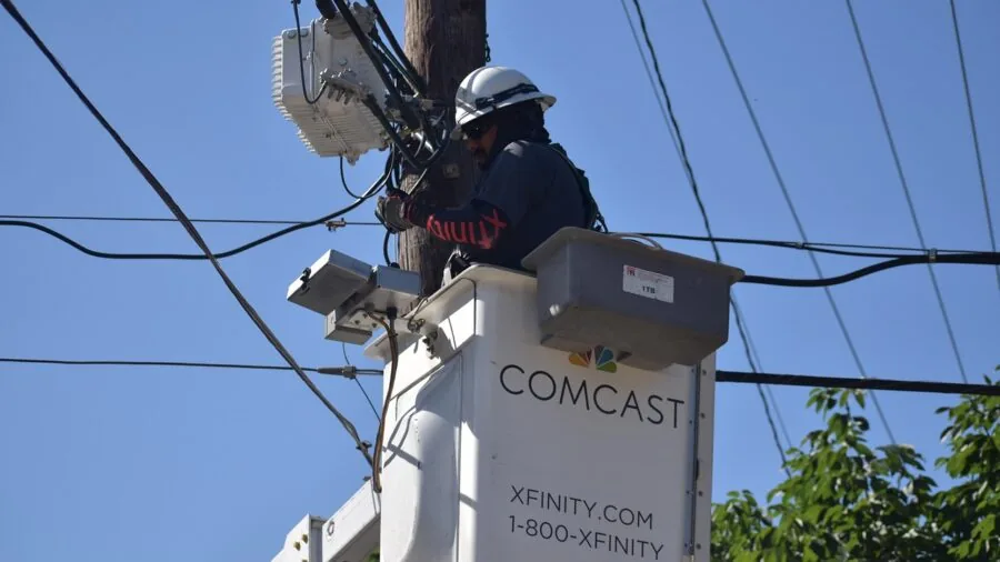 Professional installing coaxial cables during home internet setup with focus on cable quality and connections