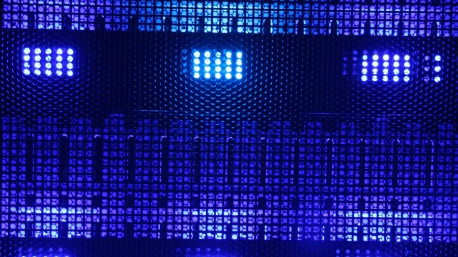 Professional IT technician monitoring data storage systems and network servers in a modern server room environment