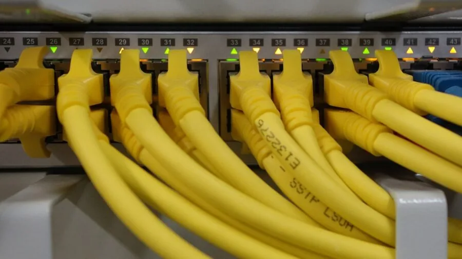 Professional managing network infrastructure and cables in server room environment