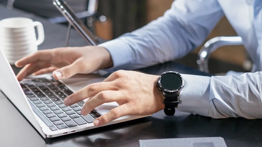 Professional person working on laptop at desk in modern office environment