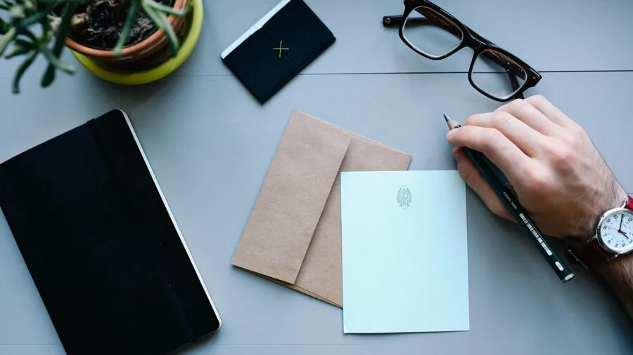 Professional printing documents at home office desk with paper stack and printer setup