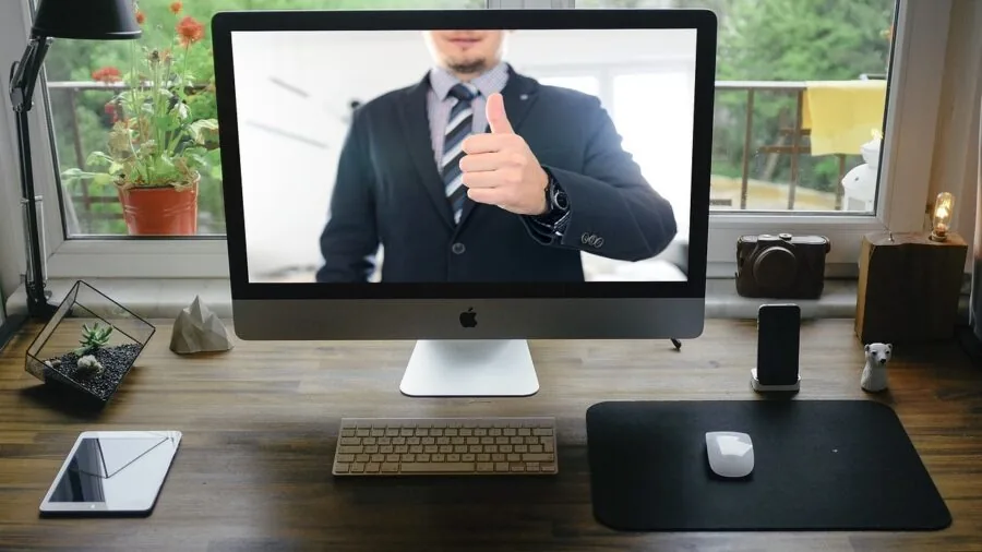 Professional woman at home desk during video conference call on computer