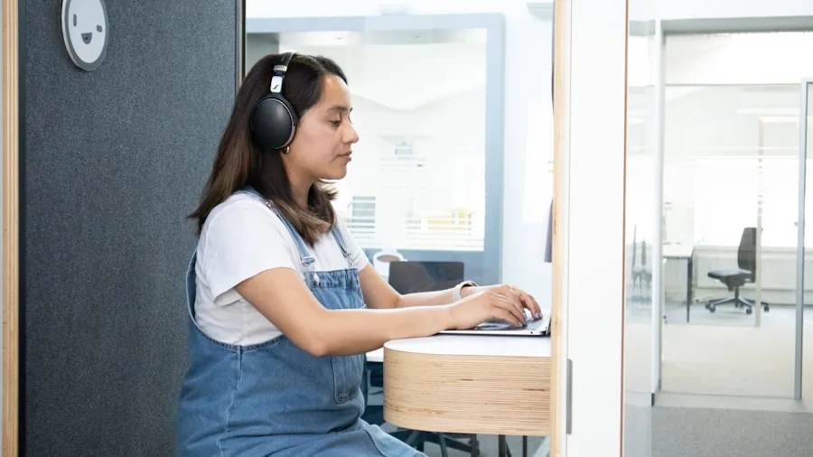Professional woman on video call wearing comfortable wireless earbuds at home desk