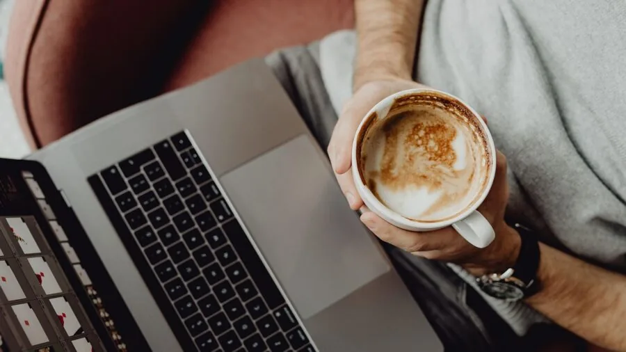 Professional working at desk during video call with natural lighting