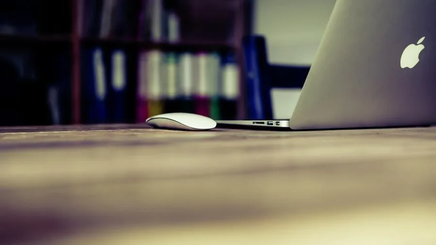 Professional working extended hours at desk with laptop, emphasizing productivity and battery efficiency
