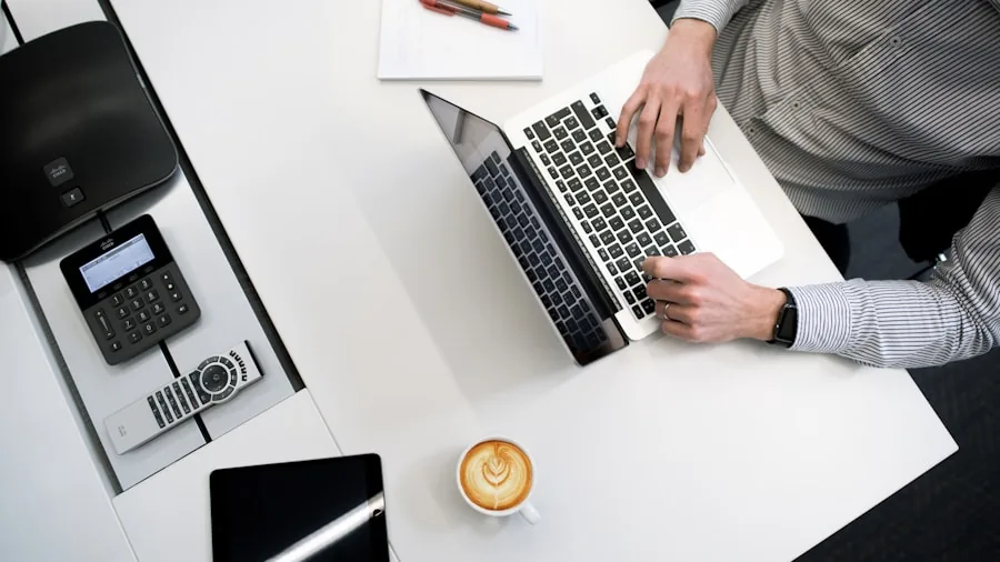 Professional working on laptop throughout the day, demonstrating extended battery usage in real-world setting