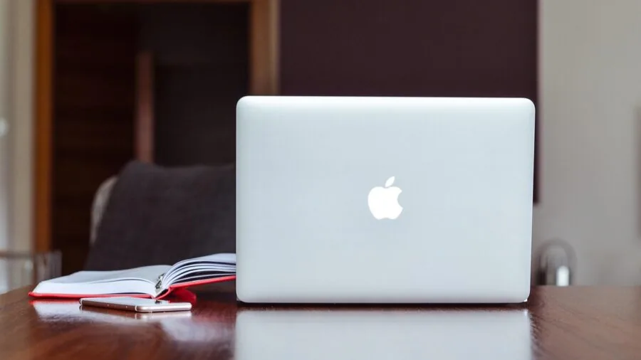 Professional workspace showing organized desk setup with laptop and multiple cables neatly arranged