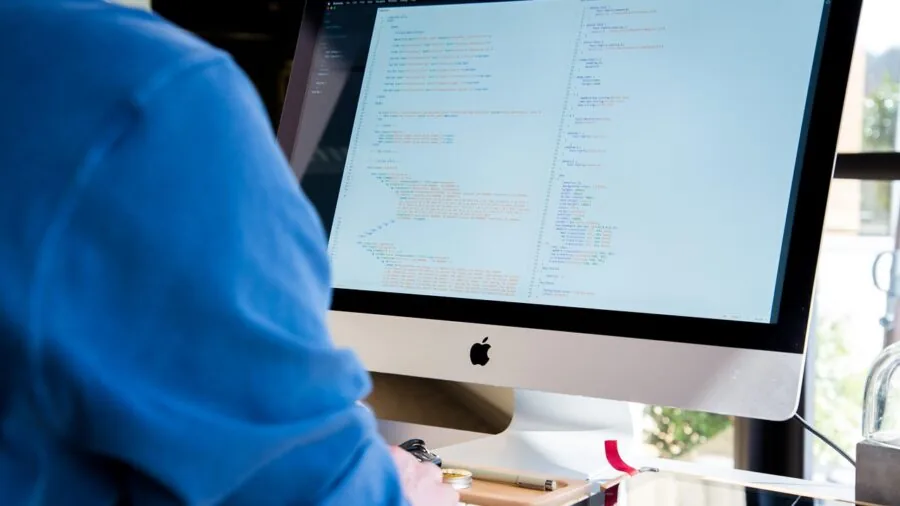 Professional workspace with curved ultrawide display showing color-accurate work environment
