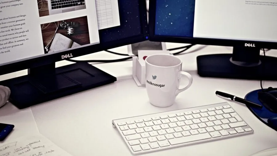 Professional workspace with dual monitors showing consistent color display during focused work session