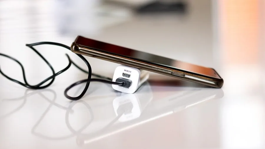 Runner checking phone battery life before outdoor training run in natural light